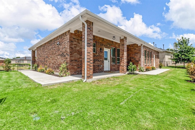 rear view of house with a yard