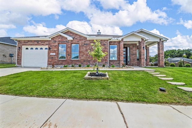 view of front of property with a front yard and a garage