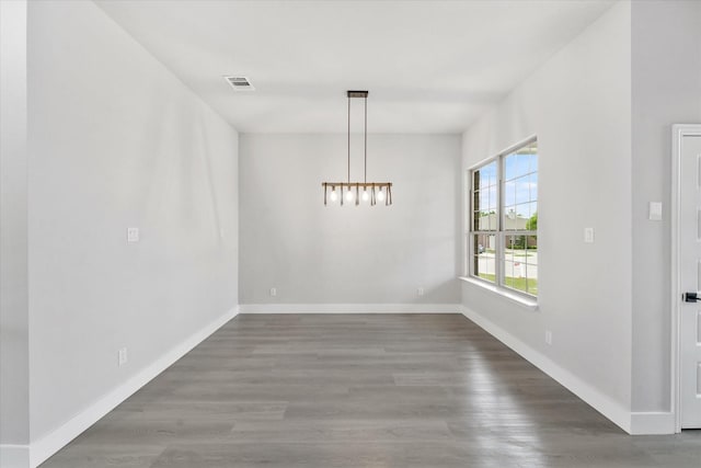 unfurnished dining area with dark wood-type flooring