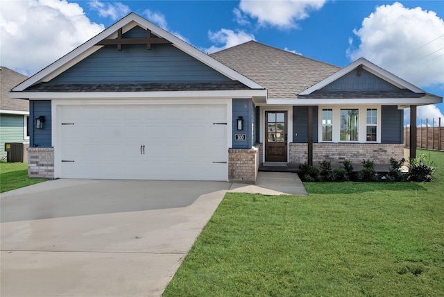 craftsman-style house featuring a garage, central AC, and a front yard