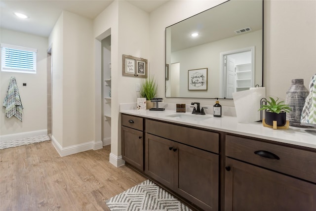 bathroom with vanity and hardwood / wood-style flooring