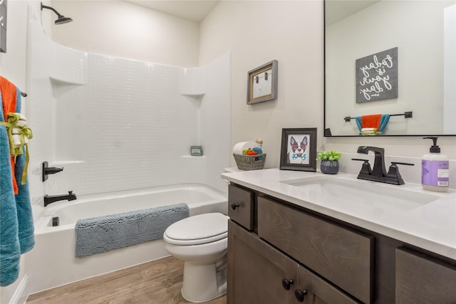 full bathroom with bathtub / shower combination, hardwood / wood-style floors, vanity, and toilet