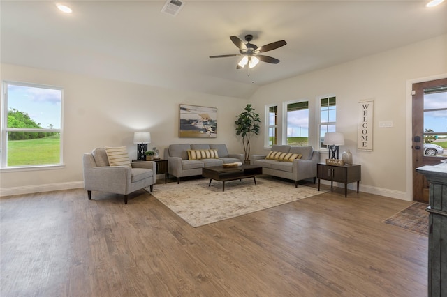 living room featuring ceiling fan, plenty of natural light, and wood-type flooring