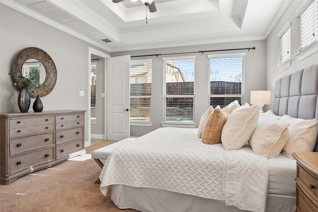 carpeted bedroom featuring ceiling fan, a raised ceiling, crown molding, and multiple windows