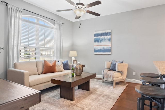 living room featuring hardwood / wood-style floors and ceiling fan