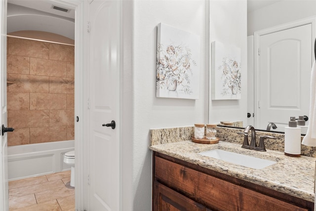 full bathroom with toilet, vanity, tile patterned floors, and tiled shower / bath