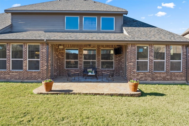 back of house with a lawn and a patio area