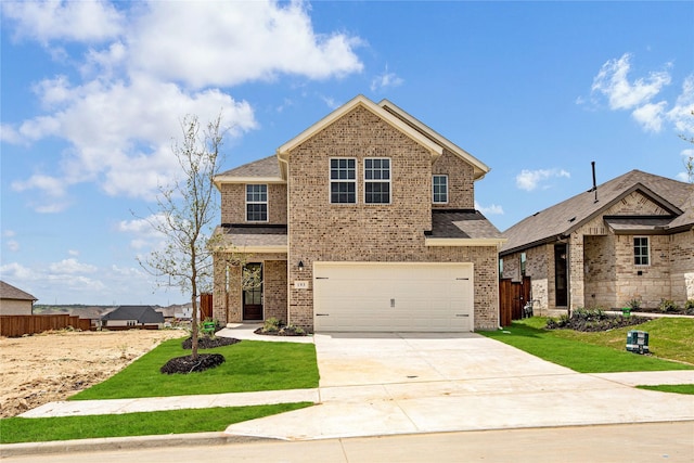 view of front of home featuring a front yard and a garage