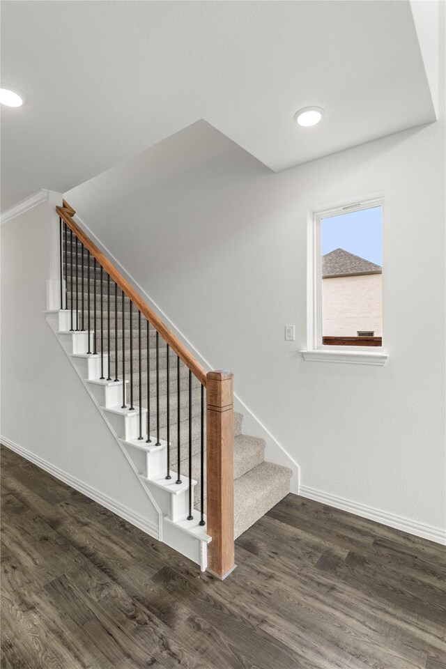 stairway featuring wood-type flooring