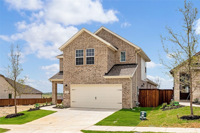 view of front of property featuring a front yard and a garage