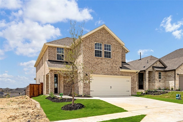 view of front of home with a front yard and a garage