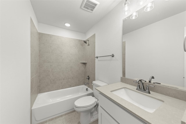 full bathroom featuring tile patterned floors, vanity, toilet, and tiled shower / bath