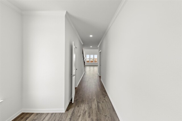 hall with wood-type flooring and crown molding