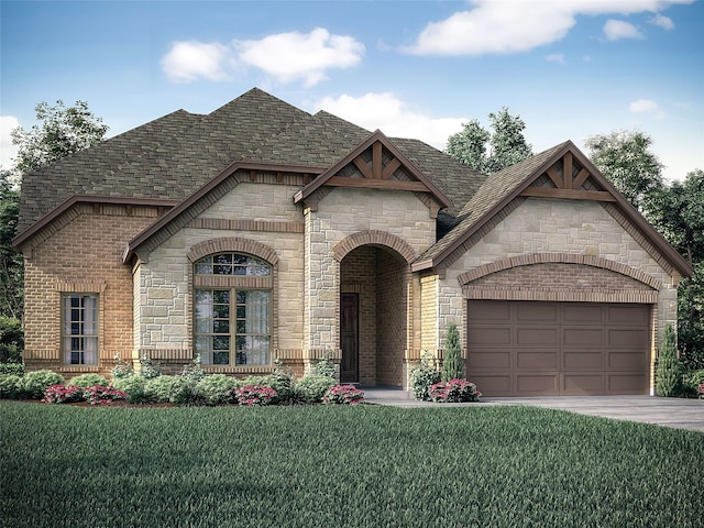 view of front of property with a front yard and a garage