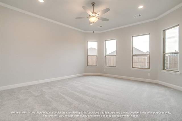 carpeted spare room featuring crown molding and ceiling fan