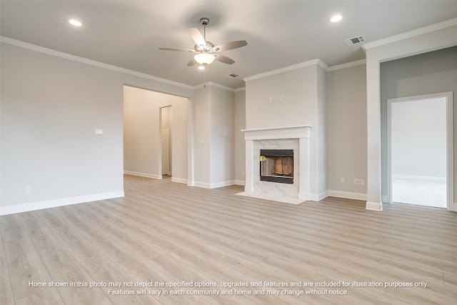 unfurnished living room with a premium fireplace, ceiling fan, crown molding, and light hardwood / wood-style flooring