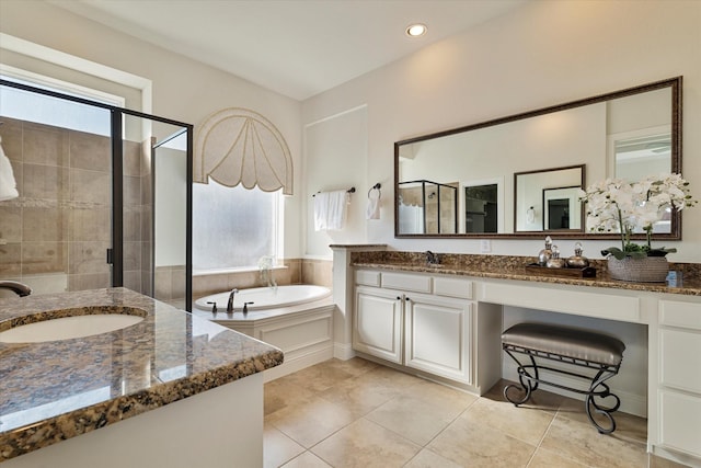 bathroom with vanity, tile patterned flooring, and plus walk in shower