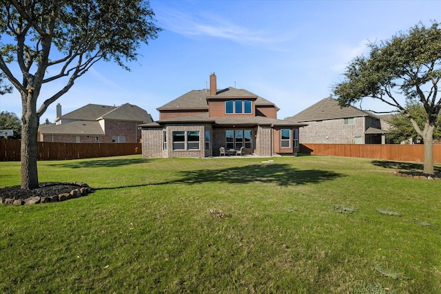 rear view of property with a yard