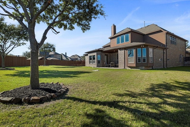 back of house with a yard