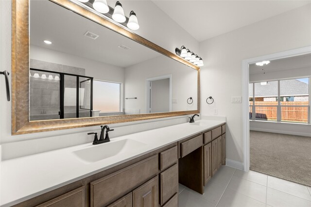 bathroom with tile patterned floors, vanity, and walk in shower