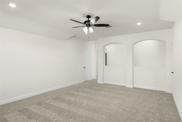 spare room with ceiling fan and light colored carpet