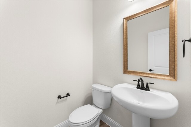 unfurnished bedroom featuring a tray ceiling, connected bathroom, ceiling fan, and light carpet