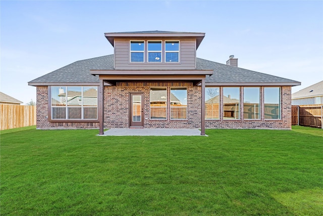 back of property featuring a yard and a patio