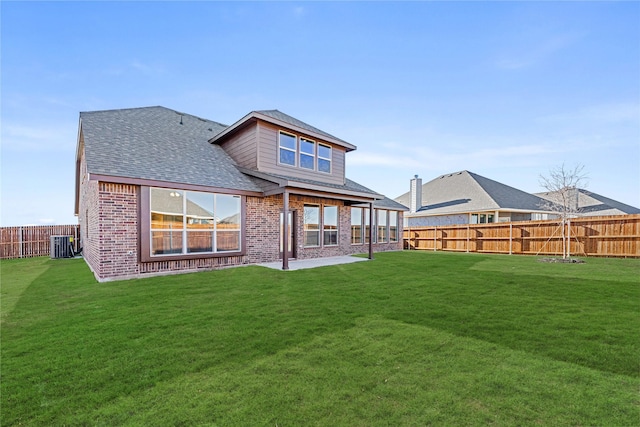 rear view of property featuring cooling unit, a yard, and a patio