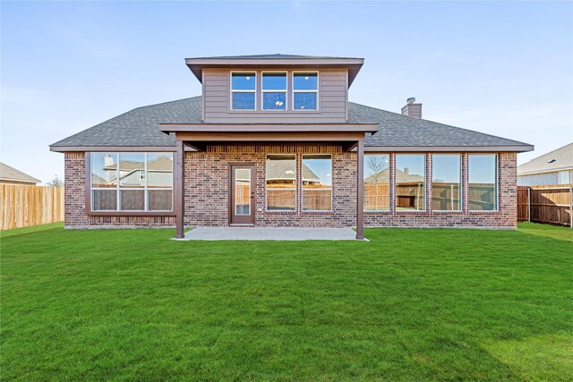 back of house featuring central air condition unit, a lawn, and a patio