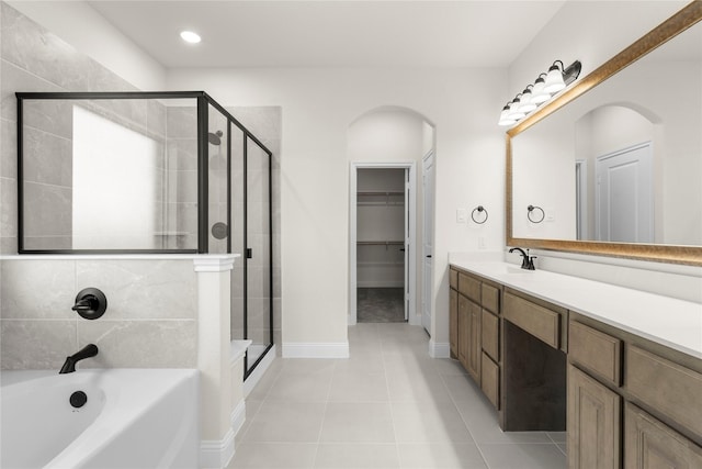 bathroom featuring tile patterned flooring, vanity, and separate shower and tub