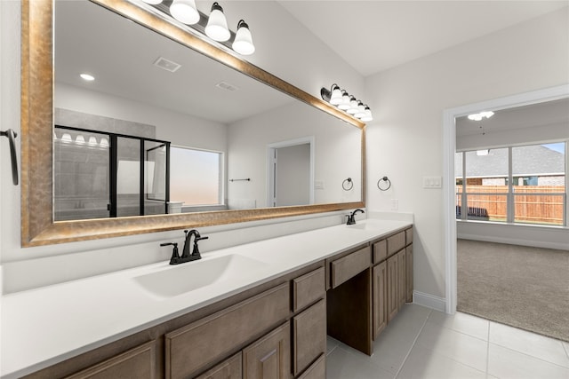 bathroom with tile patterned floors, vanity, and a shower with door