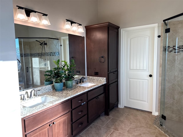 bathroom with tile patterned flooring, vanity, and walk in shower