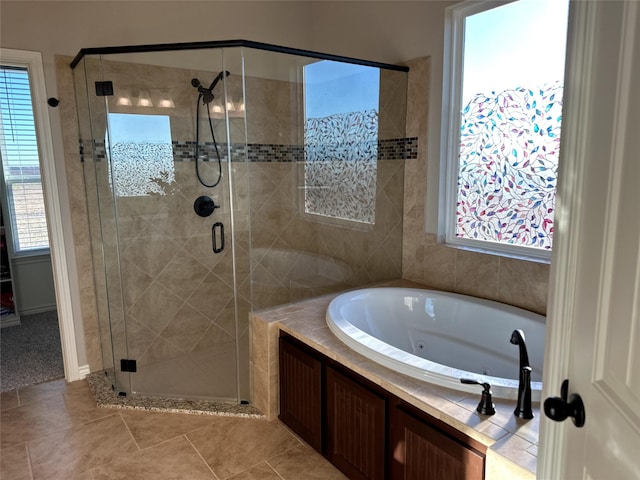 bathroom featuring tile patterned floors, plus walk in shower, and a healthy amount of sunlight