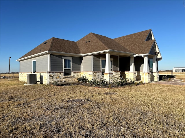 view of side of home featuring central AC unit and a lawn