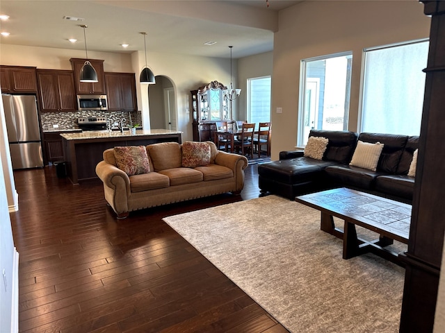 living room with sink and dark hardwood / wood-style floors