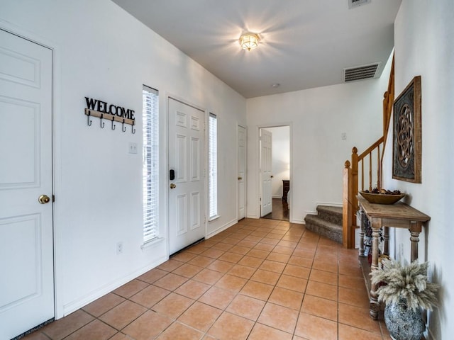 foyer entrance featuring light tile patterned floors