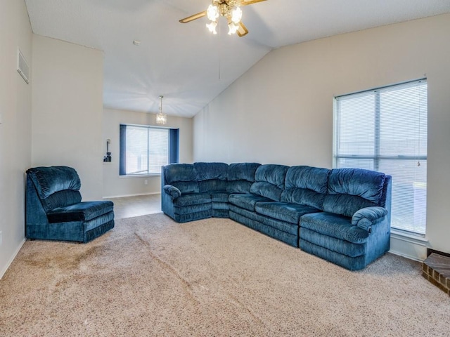 living room featuring baseboards, visible vents, lofted ceiling, and carpet floors