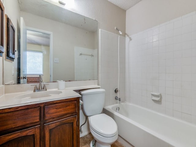 bathroom featuring tile patterned floors, toilet, a textured ceiling, tub / shower combination, and vanity