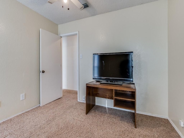 carpeted bedroom with a ceiling fan, visible vents, and a textured ceiling