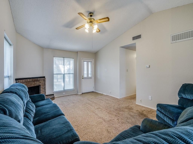 living room with lofted ceiling, a brick fireplace, carpet, and visible vents