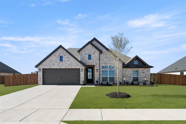 view of front of property with a garage and a front yard