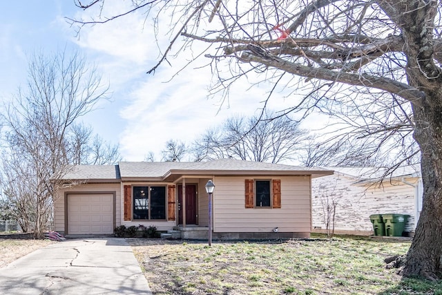 view of front facade featuring a garage, roof with shingles, and driveway