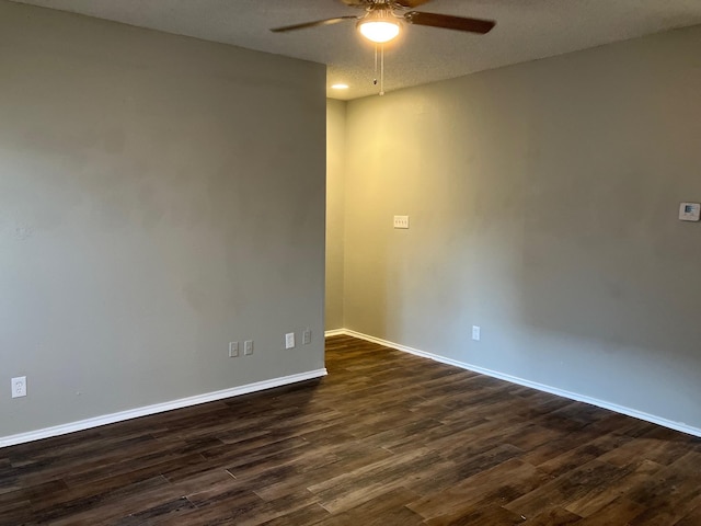 unfurnished room with ceiling fan and dark hardwood / wood-style flooring