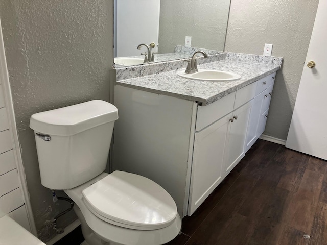 bathroom featuring hardwood / wood-style floors, vanity, and toilet