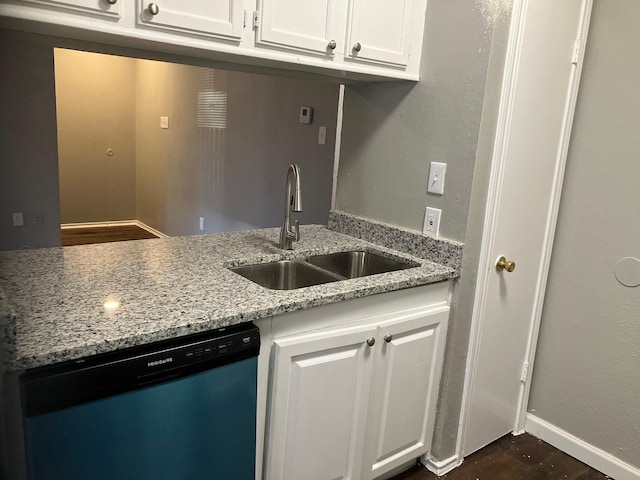 kitchen featuring light stone counters, sink, white cabinets, and stainless steel dishwasher