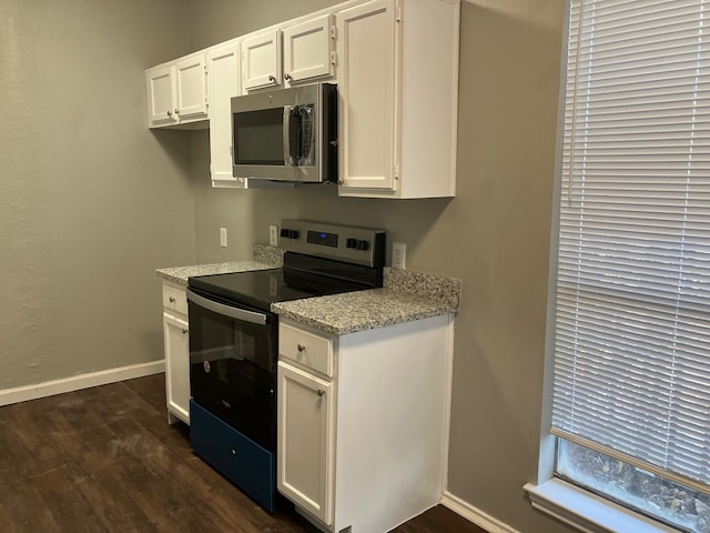 kitchen featuring white cabinetry, black / electric stove, and dark wood-type flooring