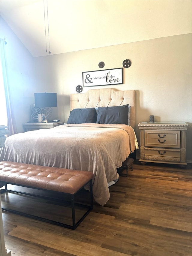 bedroom featuring dark wood-type flooring and vaulted ceiling