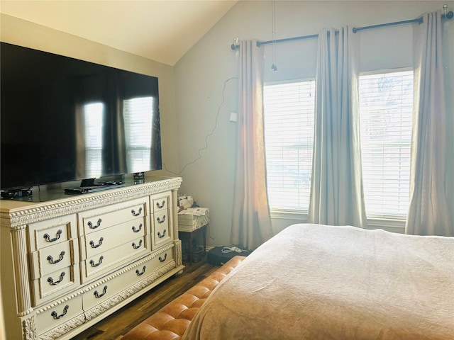 bedroom featuring dark hardwood / wood-style flooring and lofted ceiling