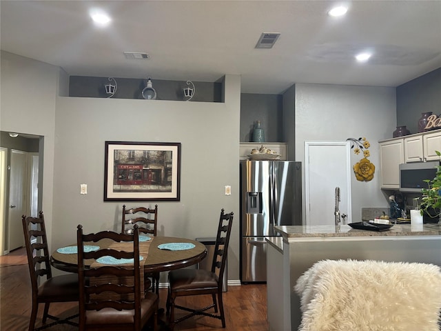 dining space featuring dark wood-type flooring