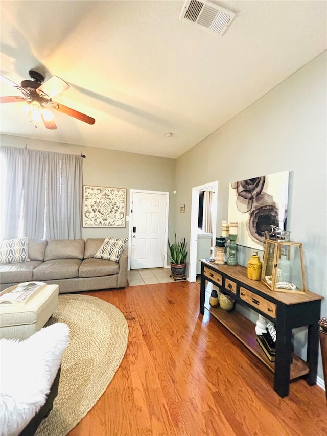 living room featuring ceiling fan and hardwood / wood-style floors